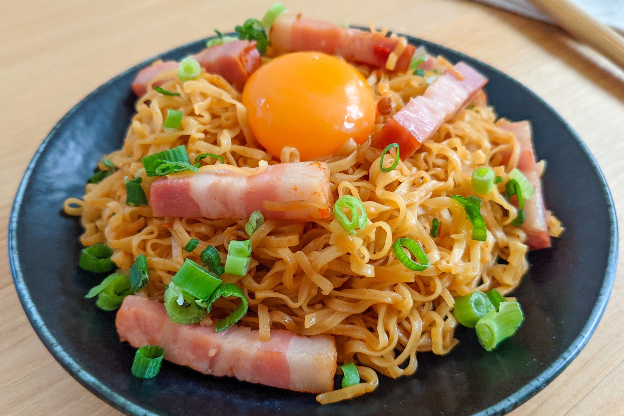 ハマごはん お手軽レシピ チキンラーメンで究極のベーコン油そば 袋の表記通りにチキンラーメンを茹でて麺とスープを別にする フライパンにごま油を入れて中火でベーコンを炒める 弱火に変えてにんにく 豆板醤 麺を加えて軽く炒める ネギ