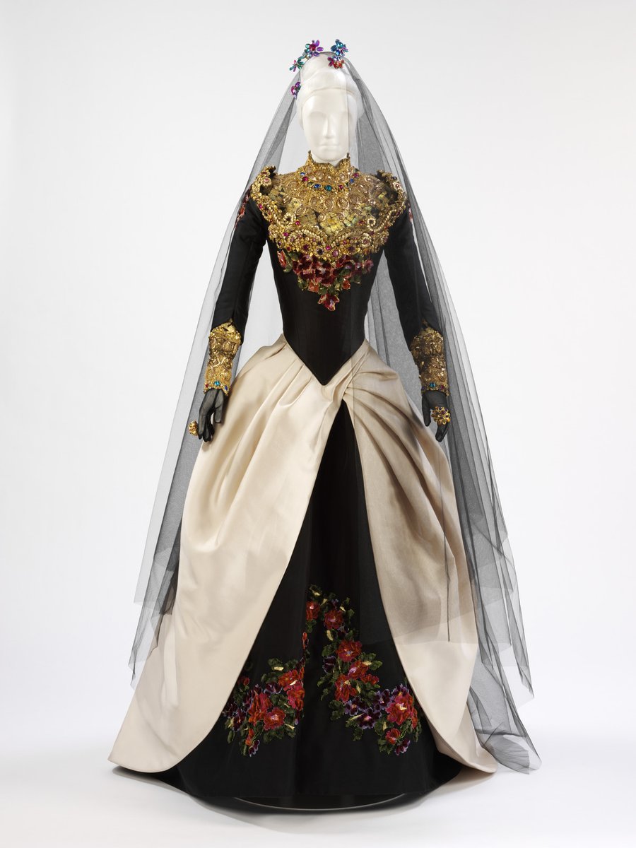 Choose your dream off-white wedding dress. 

Let's start our tentative steps down the wedding aisle with:

Qui a le droit?, Christian Lacroix (1993)
Black bodice and skirt with richly embroidered high neck in metallic threads and overskirt in off-white silk satin.