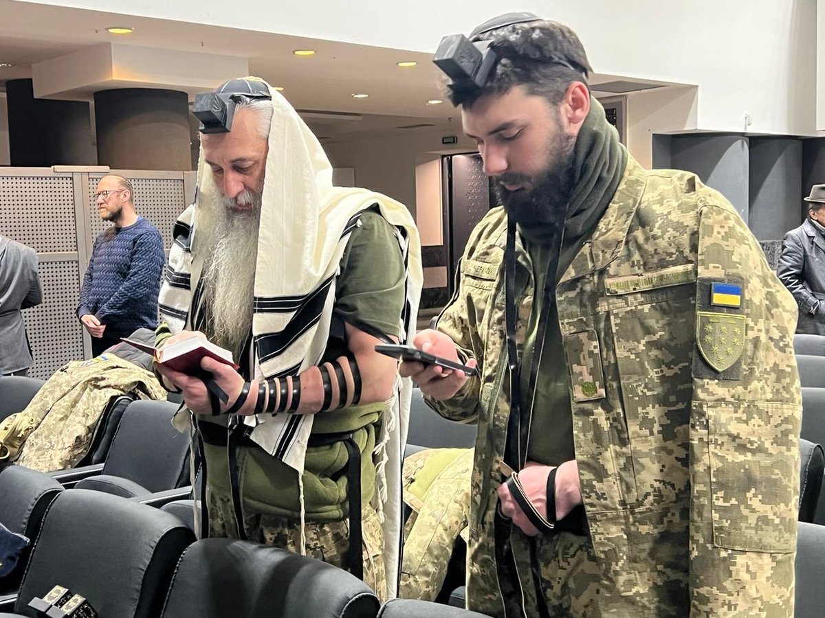 Two Jewish soldiers in the Ukrainian army—a father and son—attend morning services at a local synagogue amidst the fighting.

May they return home in peace.