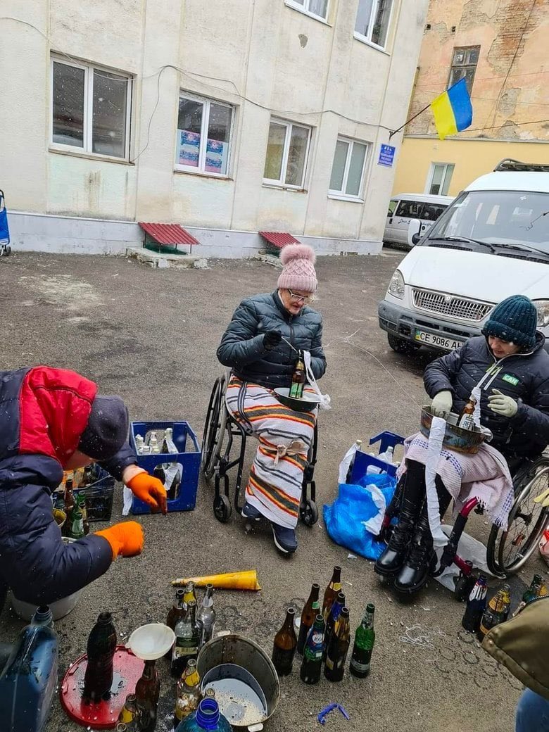 Disabled people make Molotov cocktail in Chenivtsi, Ukraine.