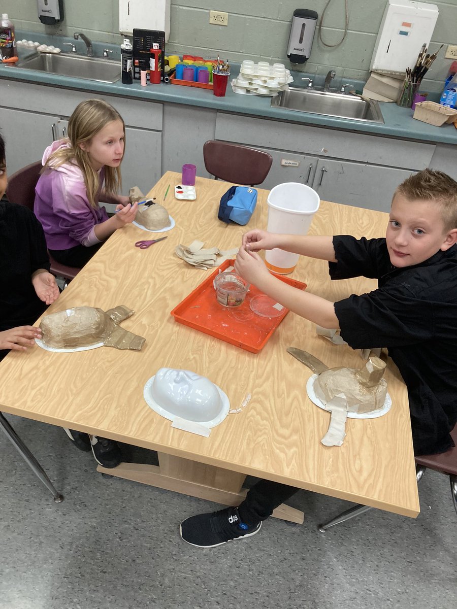 Paper mache and black light painting today!! Always so fun