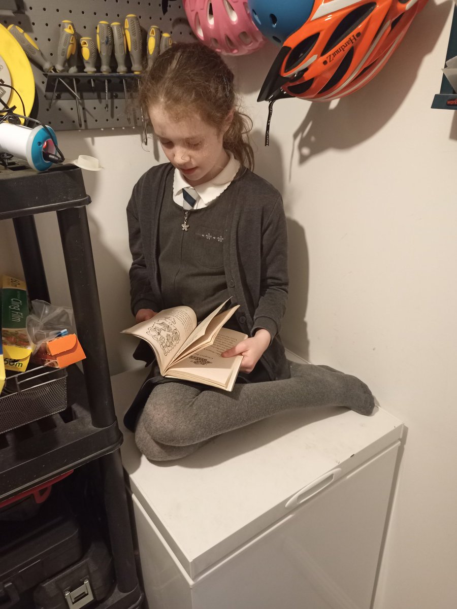 Freya relaxing on the freezer and reading her book 📚 <a href="/StDavids4/">St David's PS & NC</a>  #WorldBookDay