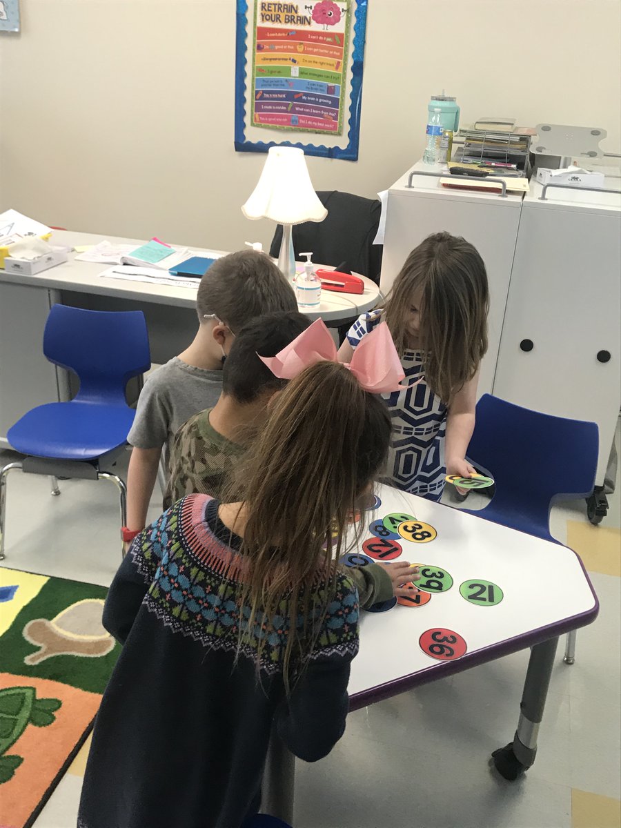 Kindergarteners building number after number with a Caterpillar number line during  Extended Learning.  #findingjoy67   #cherokeeinspires