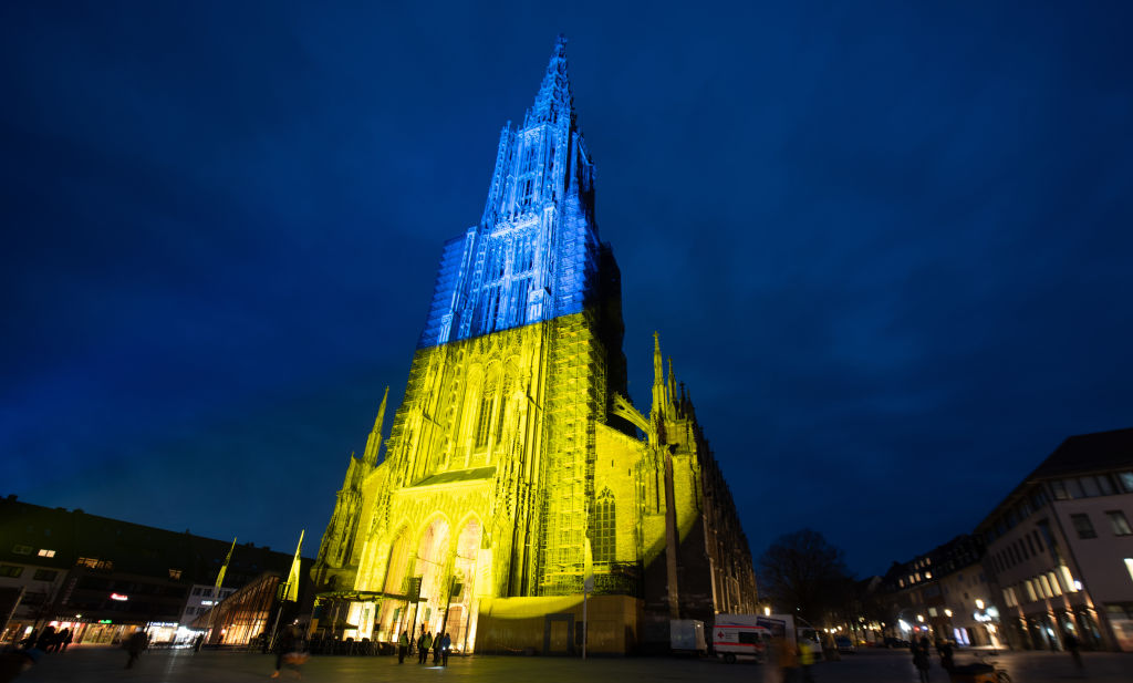PHOTO: Ulm Cathedral, the highest church tower in the world, is illuminated in the Ukrainian national colors of yellow and blue. (Getty) Get the latest updates on #Ukraine here: trib.al/vJZDyUo