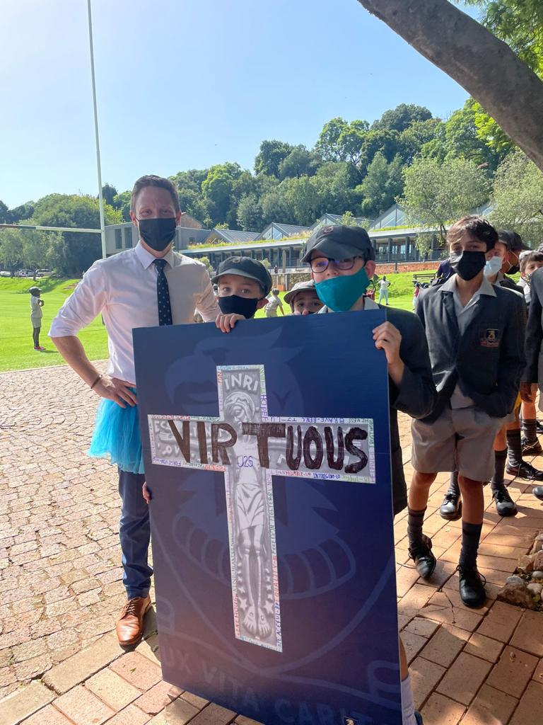 stjohns_college's tweet photo. The Prep celebrated the late Archbishop Emeritus Desmond Tutu on 22.02.2022 by wearing a tutu or two uniform items to school and decorating the Arch's cross with words that exemplified his life. They also donated more than 400 pairs of shoes for charity. #LuxVItaCaritas https://t.co/oYs988sDFC