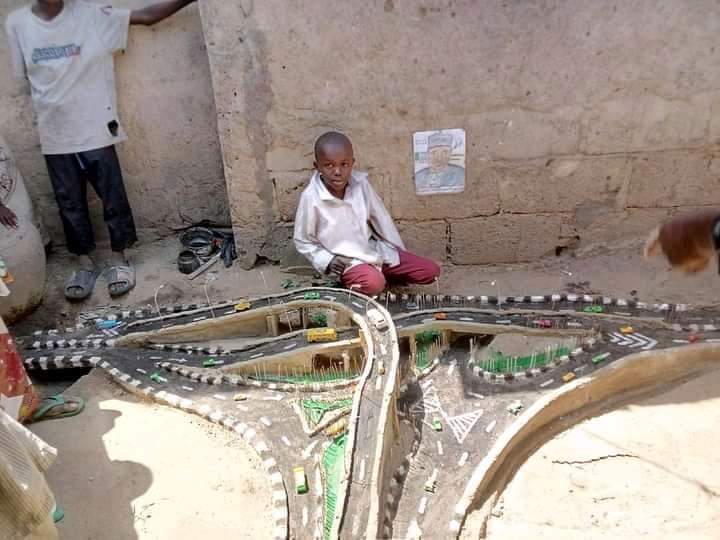 emmanex4u's tweet photo. I heard this little Boy In Borno State Builds His Scale Model Of The Newly Lauched Customs Flyover In Maiduguri,  Using Mud And Sticks . This is pure and raw talent. 

Aisha Buhari. Atiku. Tolu. Olowu. Chioma. Amokachi. Malami. Bovas. Headies. United States Of America. https://t.co/ptITsFQ4O1