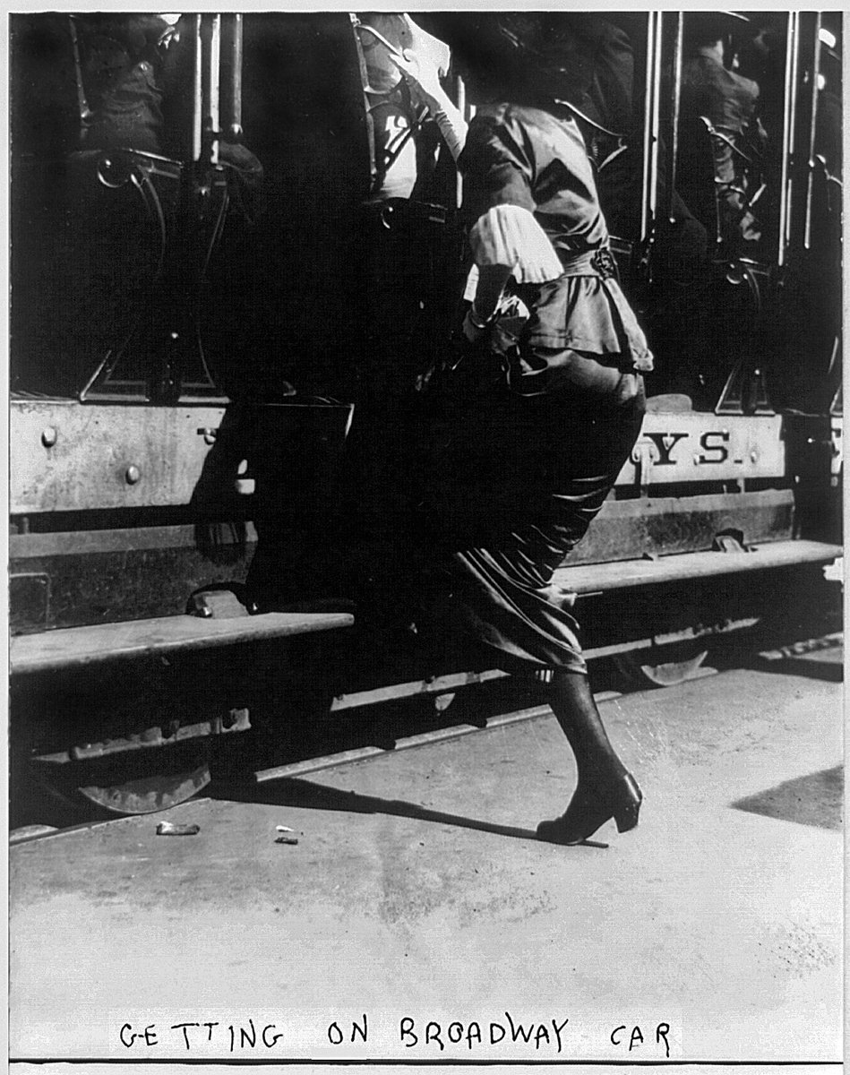 As you can see from this 1913 photo, getting on the high steps for streetcars was difficult for women wearing fashionable "hobble skirts." Getting off was even more dangerous, and women were in danger of breaking their legs...