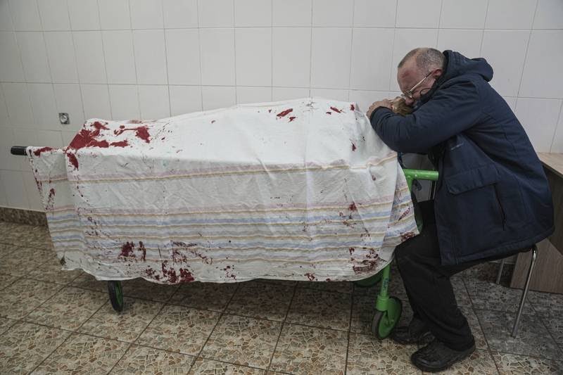 AP photo: Serhii, father of teenager Iliya, cries on his son's lifeless body lying on a stretcher at a maternity hospital converted into a medical ward in Mariupol, Ukraine, Wednesday, March 2, 2022.