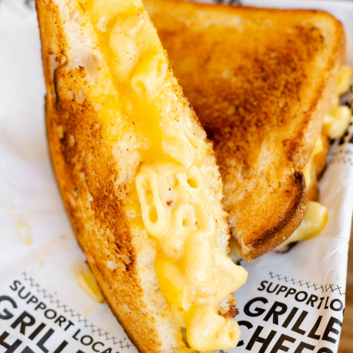 Drop an emoji that describes your reaction when you bite into our garlic buttered grilled cheese stuffed with mac-n-cheese. 🤯 #WEAIMTOCHEESE