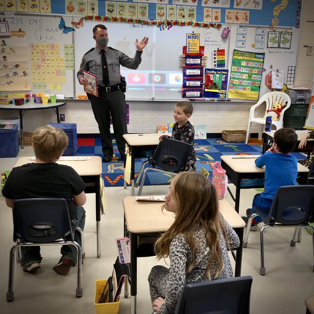 PAStatePolice's tweet photo. PERRY COUNTY - Corporal Brent Miller joined first grade students at Greenwood Elementary School, Millerstown, during #ReadAcrossAmerica week. He read several books to the students and fielded various questions about being a police officer. #ReadAcrossPA π https://t.co/jNFVlJXmFv