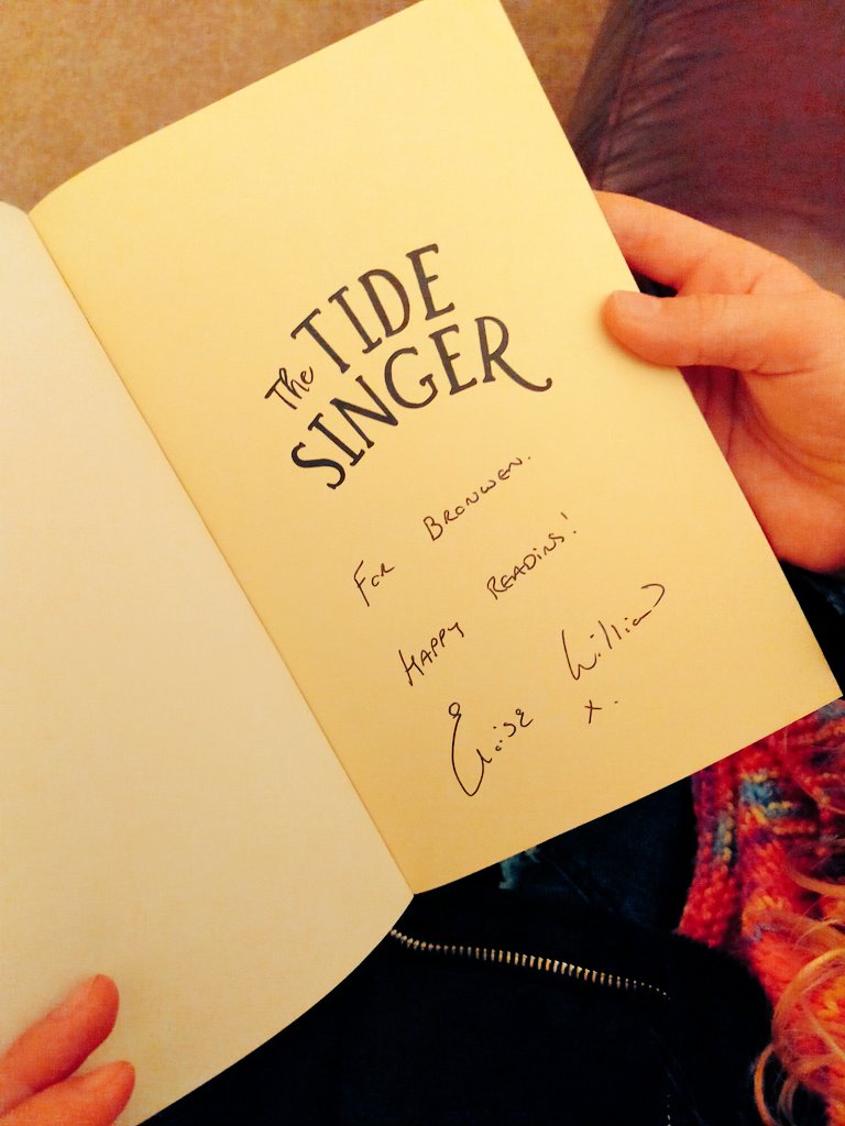 Ms_M_Israel's tweet photo. One very eager little girl ready to start reading her signed copy of The Tide Singer. Thank you to Tonyrefail Community School's Author in Residence @Eloisejwilliams . @TonyrefailCS #thetidesinger https://t.co/xvpFEKtkfo
