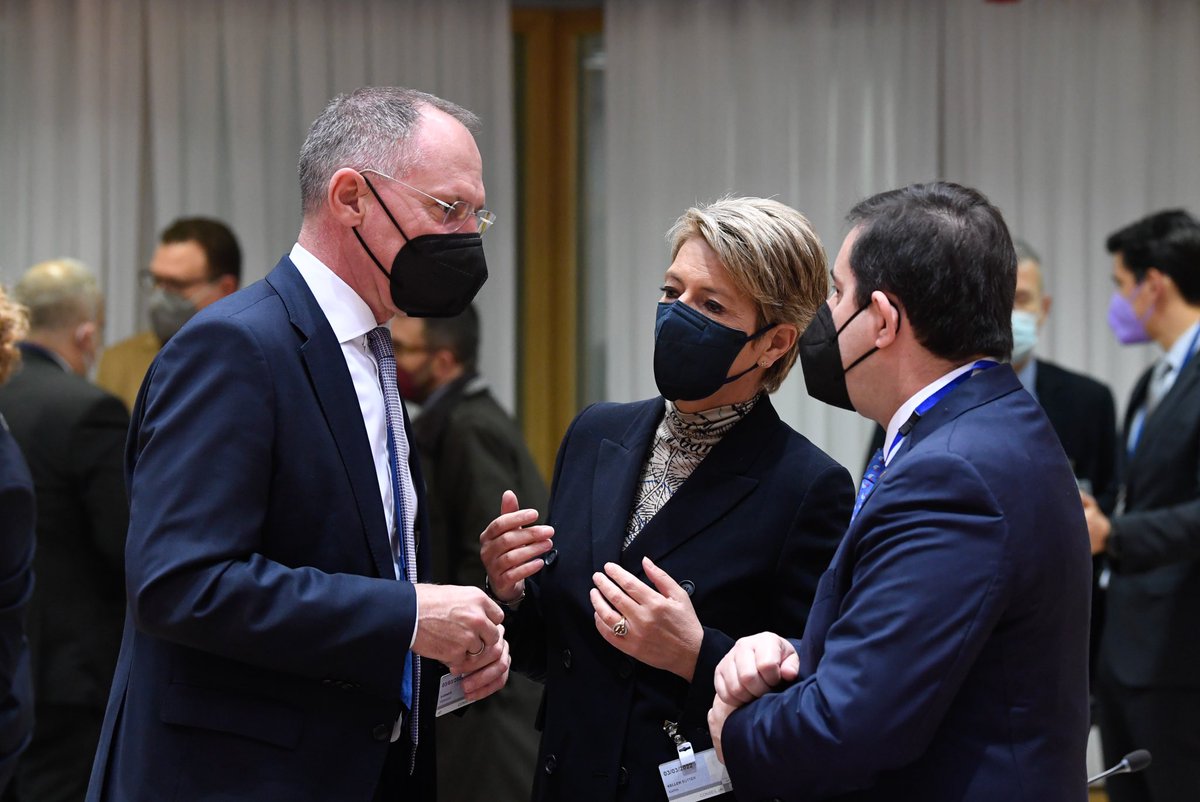 Gerhard KARNER (Federal Minister for the Interior, Austria), Karin KELLER-SUTTER (Swiss Federal Minister of Justice and Police, Switzerland) and Panagiotis MITARACHI (Minister for Immigration and Asylum, Greece) chatting. They all wear a mask.
