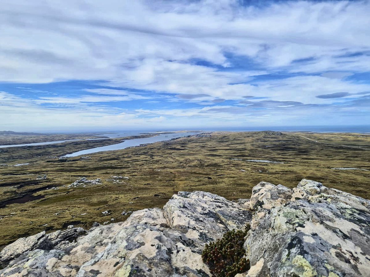 AndzB's tweet photo. Not my photo. The view looking towards Stanley from the top of Tumbledown. Taken by mini me during a 9km hike with the school yesterday. I say ‘mini me’ but she towers over me!! 

#falklands #falklandislands #tumbledown #falklandswar #1982conflict https://t.co/L1LKDocqKy