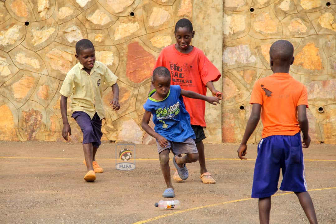 OfficialFUFA's tweet photo. The beautiful game. 
Kids on Saturday at Kabaka Kyabagu ground in Wakiso playing an empty bottle as their 'football ball'
#Innovative https://t.co/nQbg9xgPZo