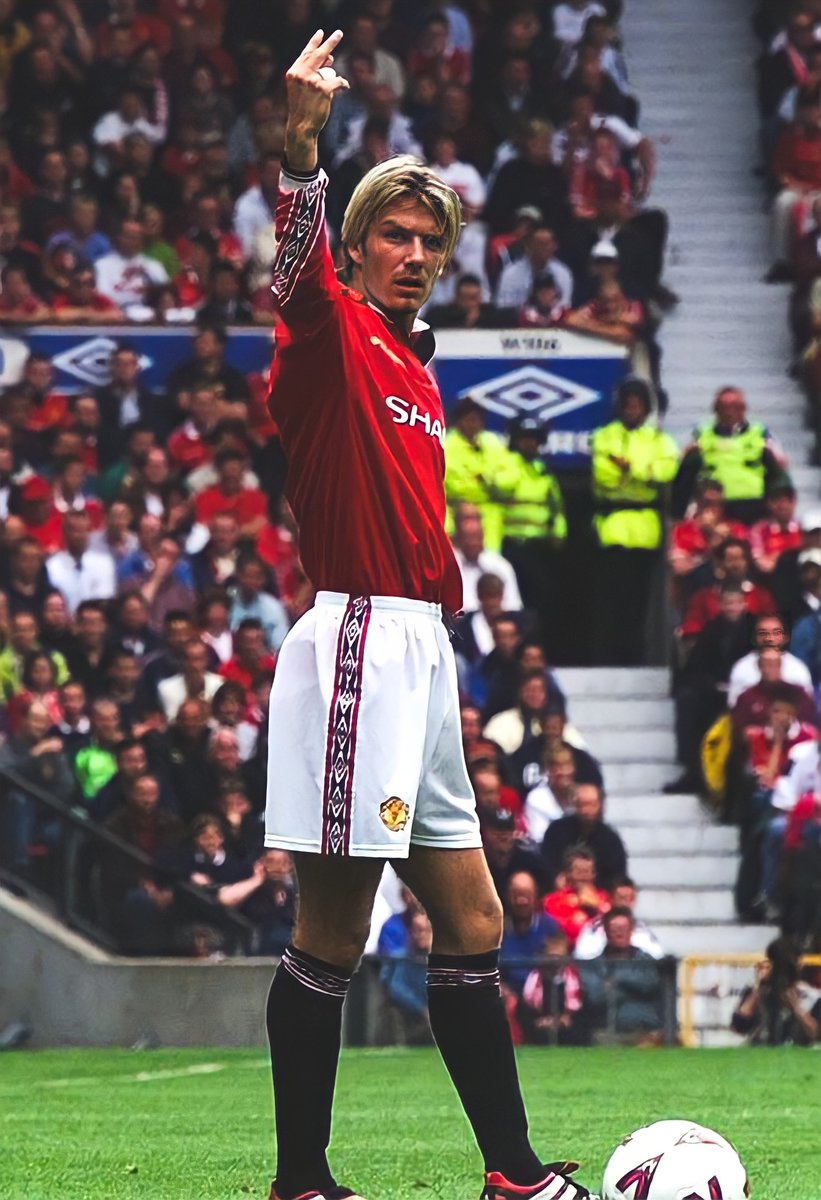 David Beckham lets the Leeds United fans know what he thinks of them as they sing songs about his wife and 5 month old son during a game at Old Trafford, 1999.