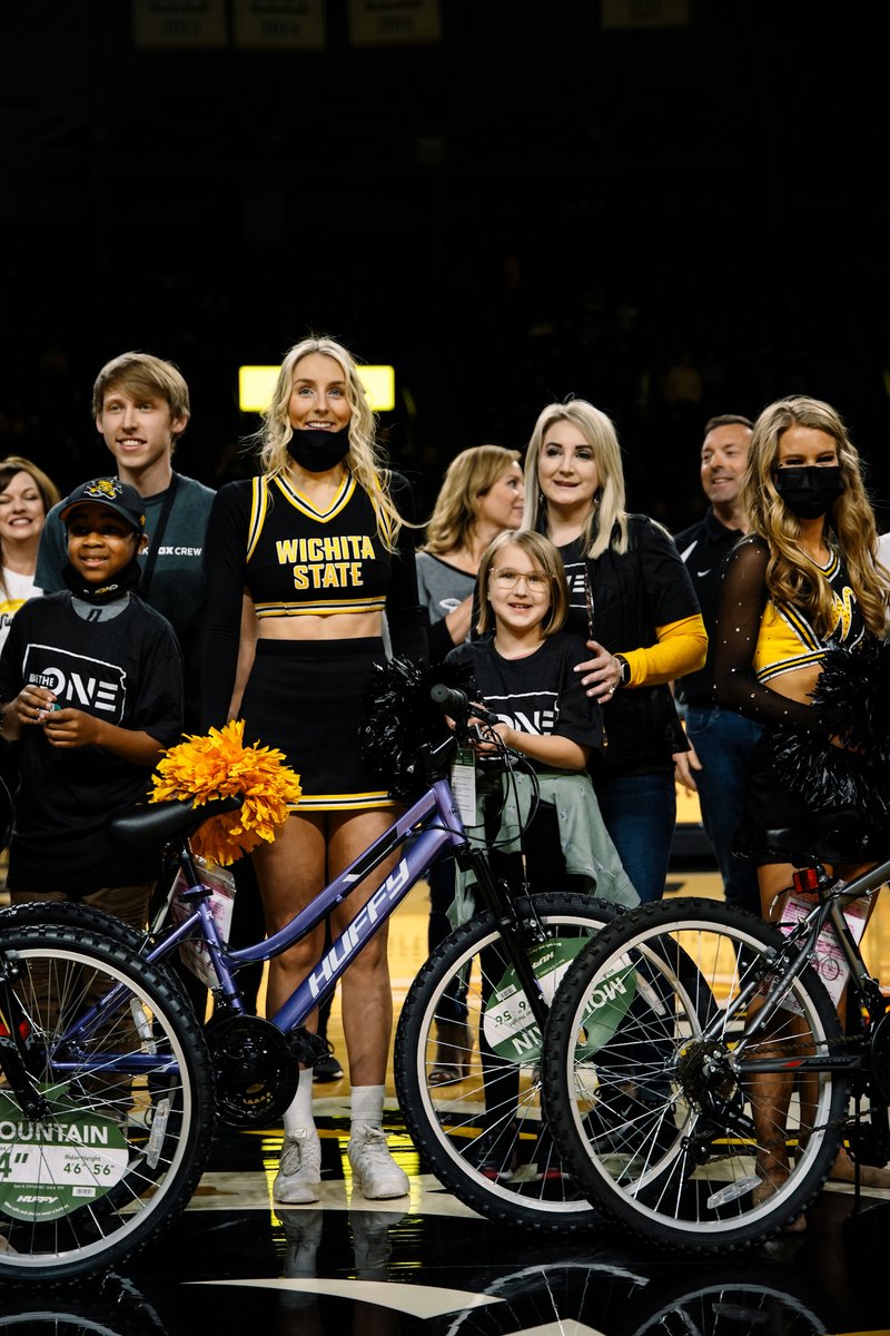 GoShockers's tweet photo. A tradition worth celebrating! 👏🚲

@meritrustcu presented a group of @BBBSA "Littles" with bicycles of their own at halftime of today's game.

We're proud to support #BBBS and their vision to provide a mentor for every child who needs a positive adult in their lives. https://t.co/XYlG50bTB9