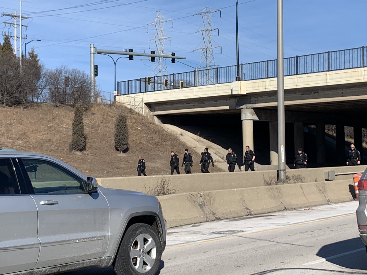 Tense scene on a Sunday afternoon in the #Milwaukee suburbs - police on foot, not vehicles, filling the lanes on I-894 westbound after report of shots being fired from a vehicle. Traffic at a standstill approaching the closed portion of the interstate.