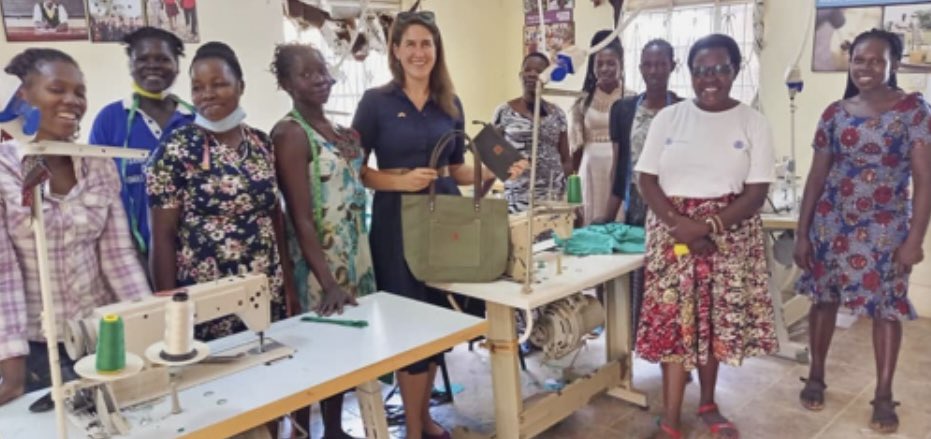 <a href="/WendAfrica/">WENDAFRICA</a>, founded by partner <a href="/Jolly/">Jolly</a> Grace Okot Andruvile, 2nd from right, trains women to sew handbags &amp; backpacks.  Proceeds educate their children, and <a href="/Gendercide/">Paul Evans</a> Awareness Project helps with overlooked girls.  US Embassy staff, center, is facilitating a deal with Amazon!