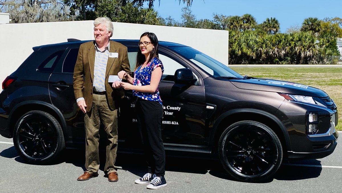 Craig Conway gives the 2022 Kia Outlander keys and $1000 to Chisholm Elementary’s Madison Miller, Volusia County Teacher of the Year.