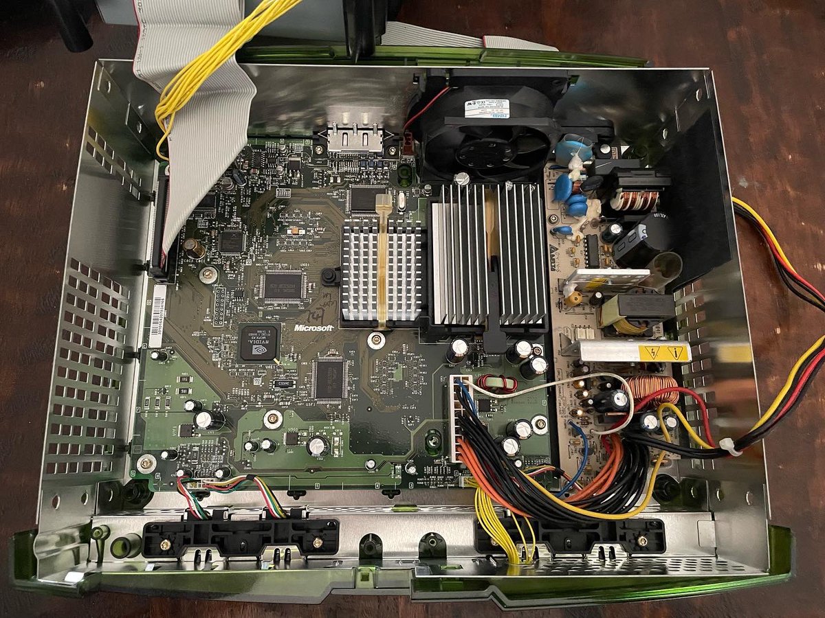 OutdateRef's tweet photo. Opening up my #xboxes to check for leaking clock #capacitor. Lucky me, both of my consoles are the later revision without that flawed cap. So a quick dust off & put it back together. #xbox #retro #console #gaming https://t.co/mzJMlxNtBM