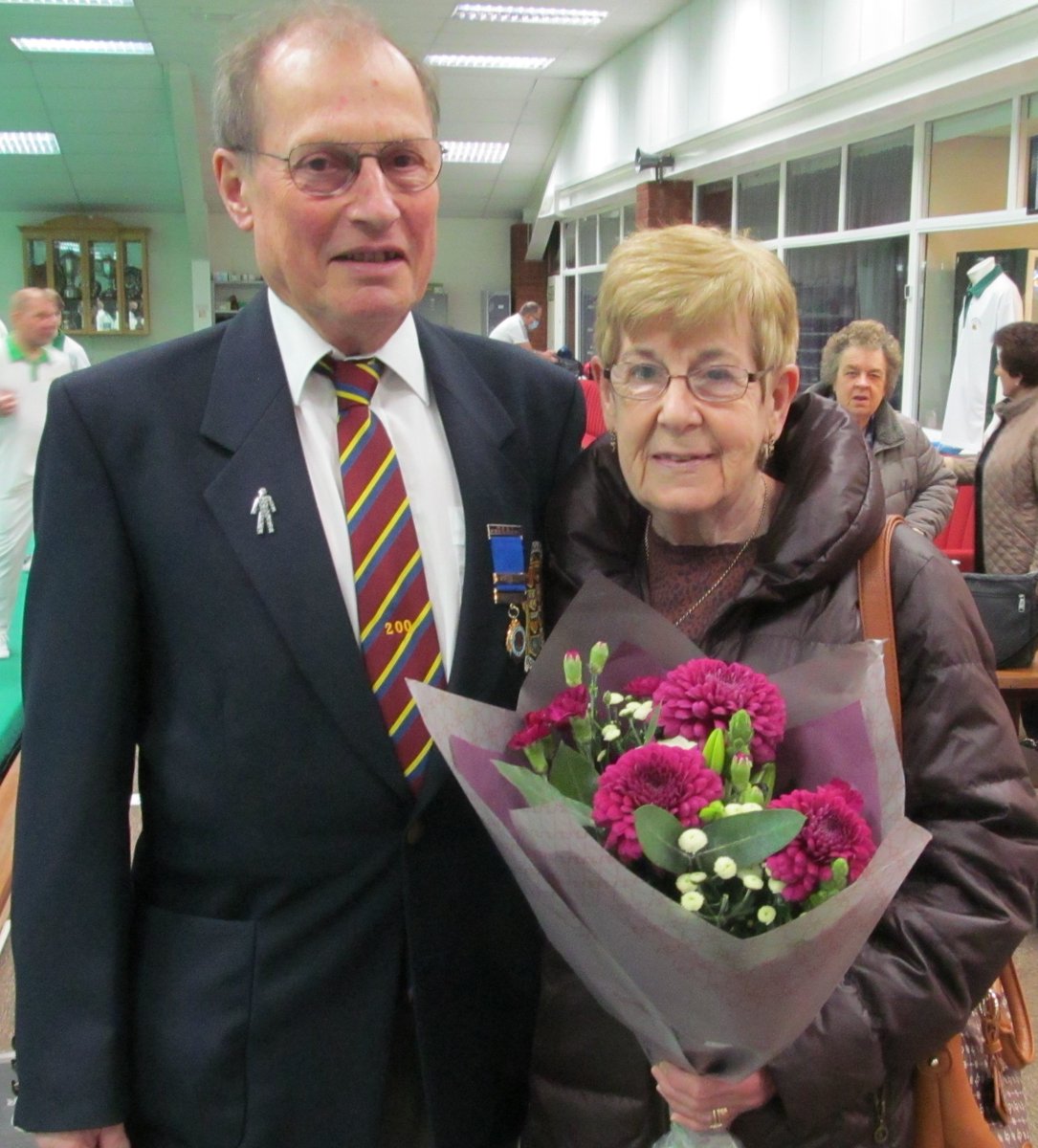 CoPBC's tweet photo. Club members Norma and Malcolm Squires pictured (Thanks Mel Beck) were presented with wine and flowers prior to Northants v Hunts Derbyshire Trophy match Sunday 20th. Feb. Malcolm retiring as Derbyshire Trophy team captain. https://t.co/3oo7YR3xA6