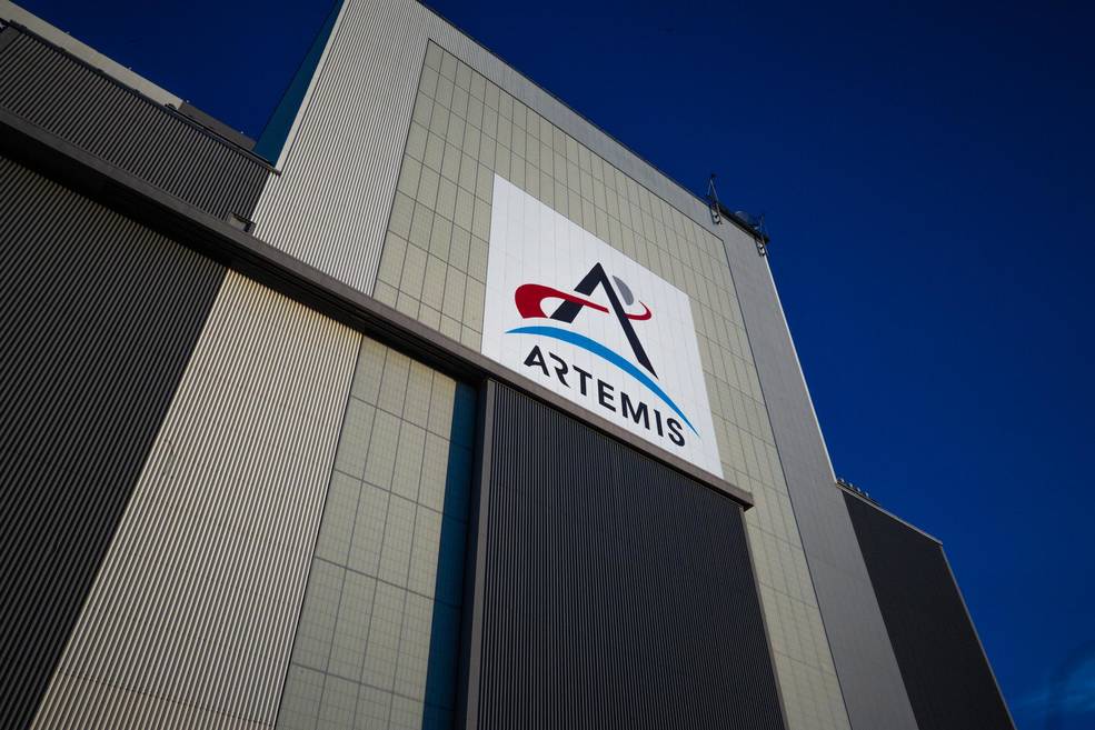 An image of the Vehicle Assembly Building door with the Artemis logo above the entrance. 