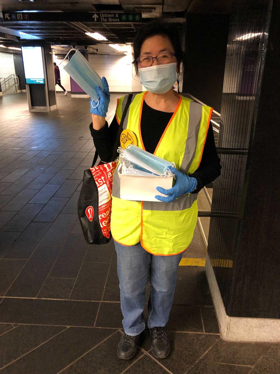 A volunteer offering free masks at Grand Central station.