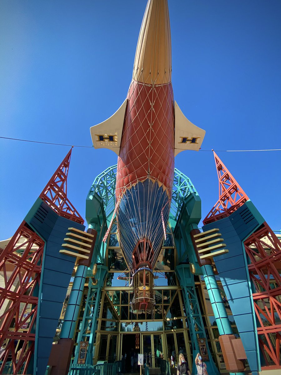 CafeFantasia's tweet photo. The exterior of #Videopolis was designed as an airship hangar, with the Hyperion (from the 1974 film The Island at the Top of the World) jutting out of its entrance. 🎈 #DisneylandParis https://t.co/YTl0FlByW4