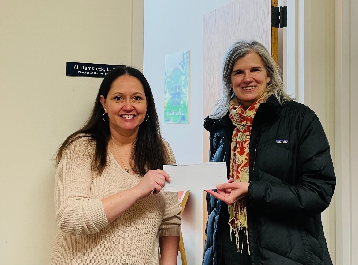 The Community Fund of Darien's Touch A Life fund helps Darien Residents in need. Janet King, TCF ED, presenting check for a local neighbor's fuel bill to Ali Ramsteck, Town of Darien Director of Human Services.