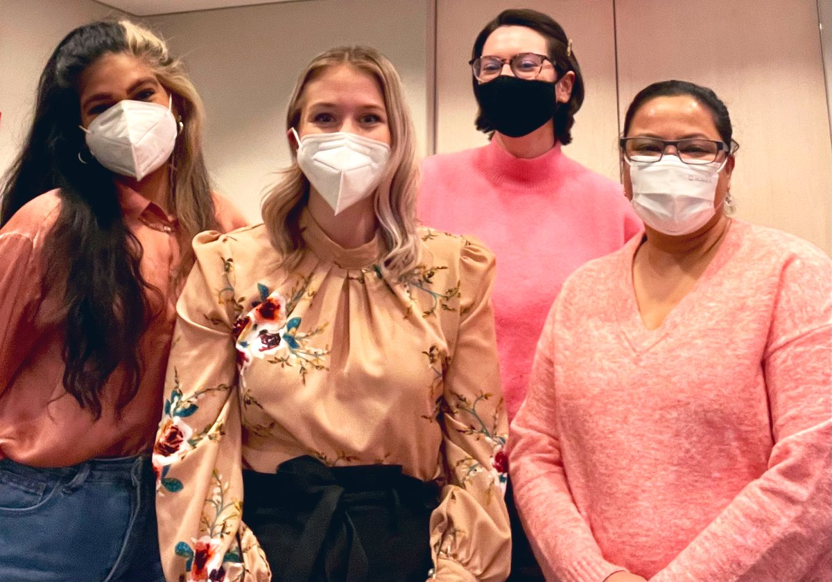 Four members of the Mayor’s staff wearing k95 masks and varying shades of pink, smiling.