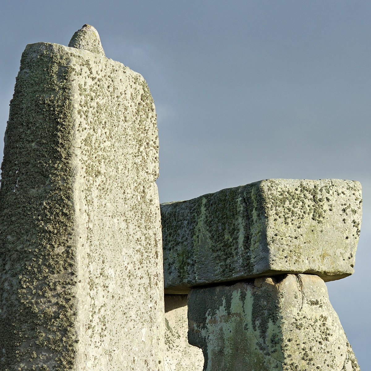A photograph of Stonehenge, showing the stones with cloudy grey blue skies behind them.