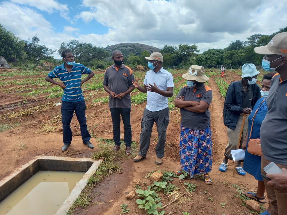 CAREZimbabwe's tweet photo. Our Country Director @pcsikana is visiting @ZRBFZIM funded #ECRAS project in Mwenezi , Ward 2 where the communities were supported to construct Muzezegwa dam which is now serving over 250 households with water for irrigation and drinking water for livestock. https://t.co/zM9V2PlGHD