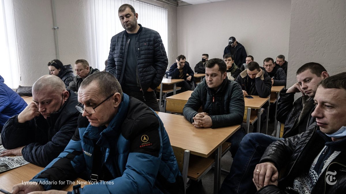 nytimes's tweet photo. Ukrainians waited to hand in their documents and complete medical checks as they volunteer for the military at a center in Kramatorsk, eastern Ukraine. The nation's defense minister has urged anyone with a Ukrainian passport to enlist. https://t.co/cYF6fIoH7u https://t.co/RTv2HOoCQ3
