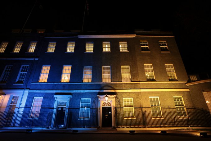 The front of Downing Street lit up blue and yellow.