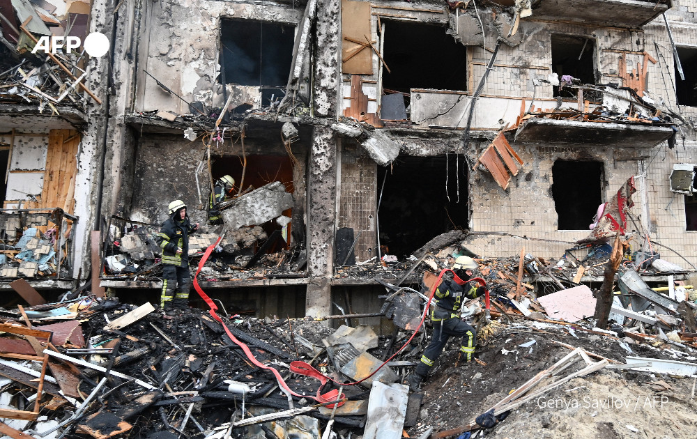 Firefighters work at a damaged residential building in a suburb of the Ukrainian capital Kyiv