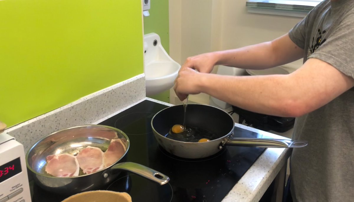 Juniper_Sally's tweet photo. Our newly appointed STR worker Aaron rustling up some butties this morning for Juniper’s mutual help meeting! (I promise we didn’t serve the bacon like this) 😂 #happyfriday @GMMH_NHS @Safewards @nigelparkhouse1 @Alison_Mills1 @PaulEndley @SheilaH78888923 https://t.co/TZ4x1a1pew