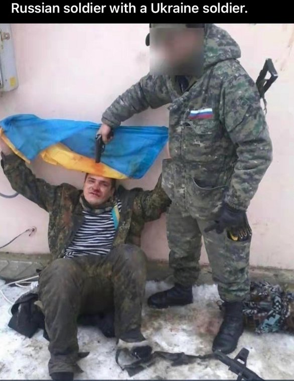 Gurleen3805's tweet photo. Ukrainian soldier with a proud flag in front of a Russian soldier. 

#UkraineRussia #Ukraine https://t.co/6xohvFcGsQ