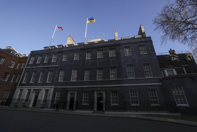 Union flag and flag of Ukraine fly above Downing Street
