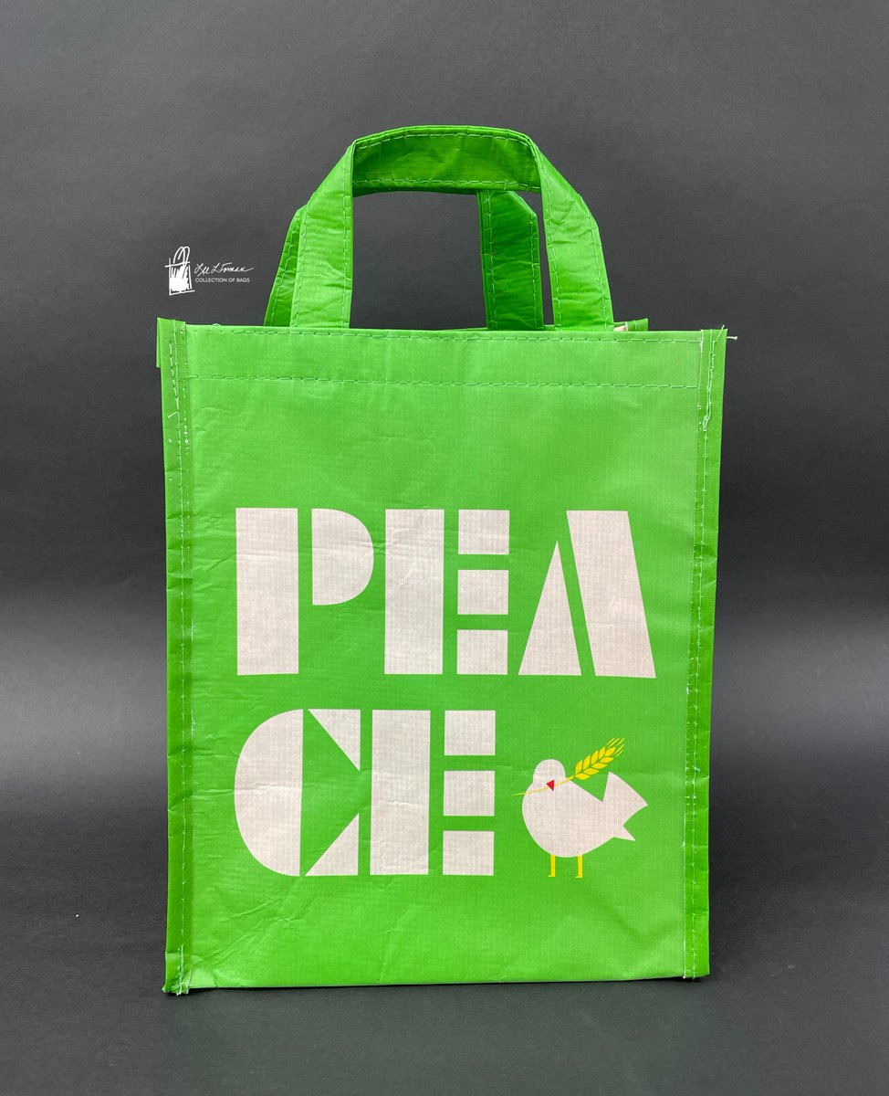 56/365: Today's bag is made from a bright green recycled plastic fiber. It features white block letters spelling out 'PEACE' alongside a dove holding a yellow wheat sheaf.