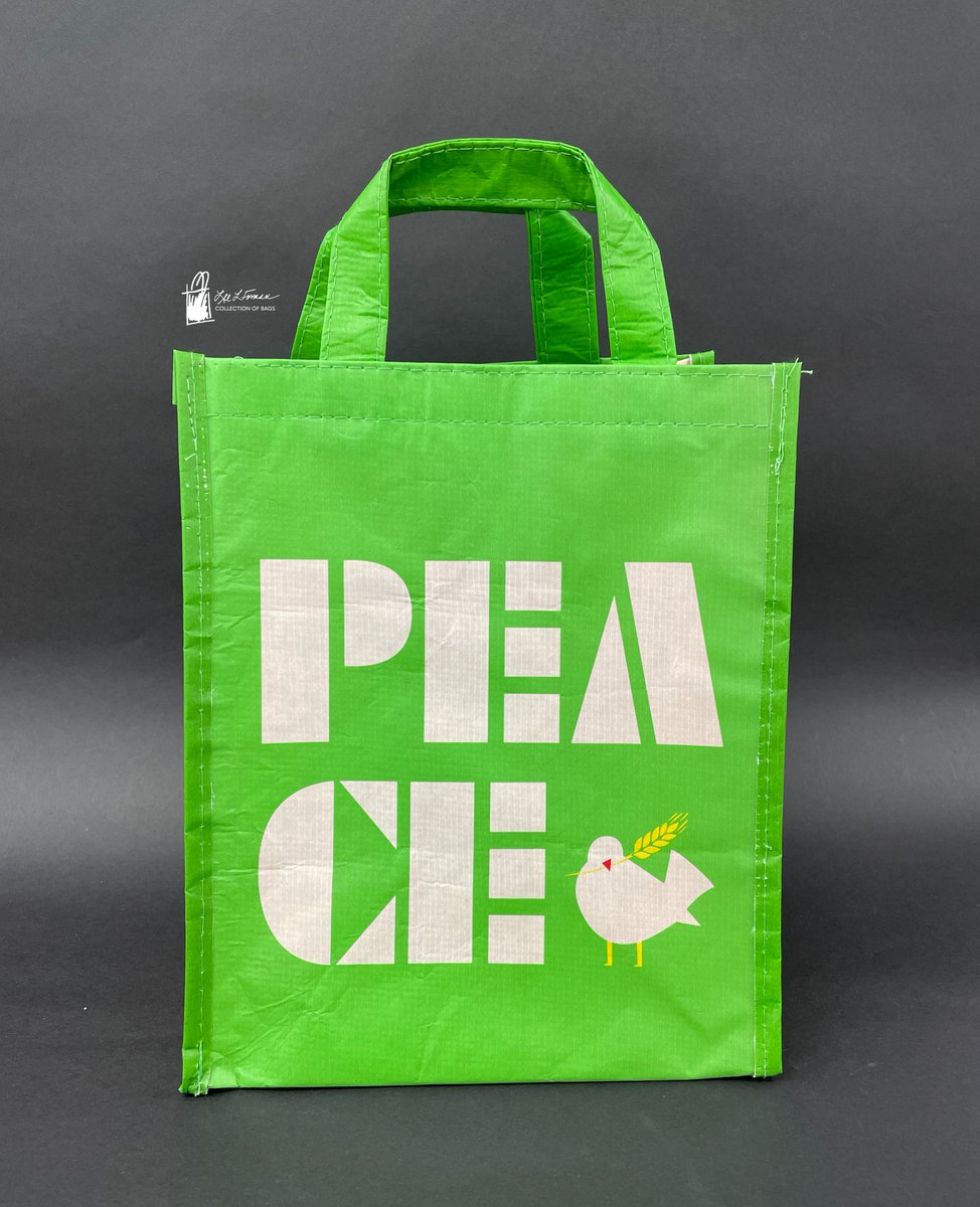 56/365: Today's bag is made from a bright green recycled plastic fiber. It features white block letters spelling out 'PEACE' alongside a dove holding a yellow wheat sheaf.