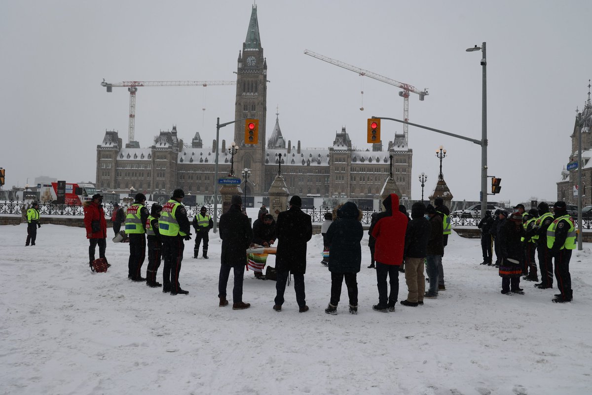 A delegation of Algonquin Elders and community members conducted a cleansing ceremony at the intersection of Wellington and Metcalfe today. (1/2)