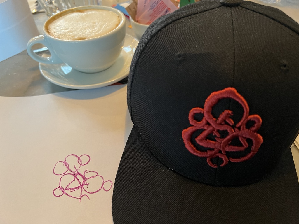 _ThisIsAsh's tweet photo. Out for lunch with the kids and I asked my daughter what she was drawing… She just pointed at my hat. @Coheed #Keywork https://t.co/IMQELeMGAh