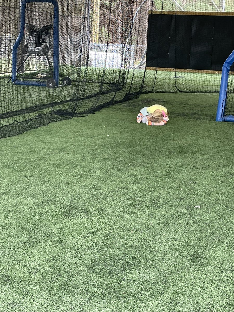 leslieirons's tweet photo. Coach’s kid life, curled up in an opposing team’s batting cage trying to stay warm and not get hit by a foul ball. @derekirons https://t.co/11eM8uKH9z