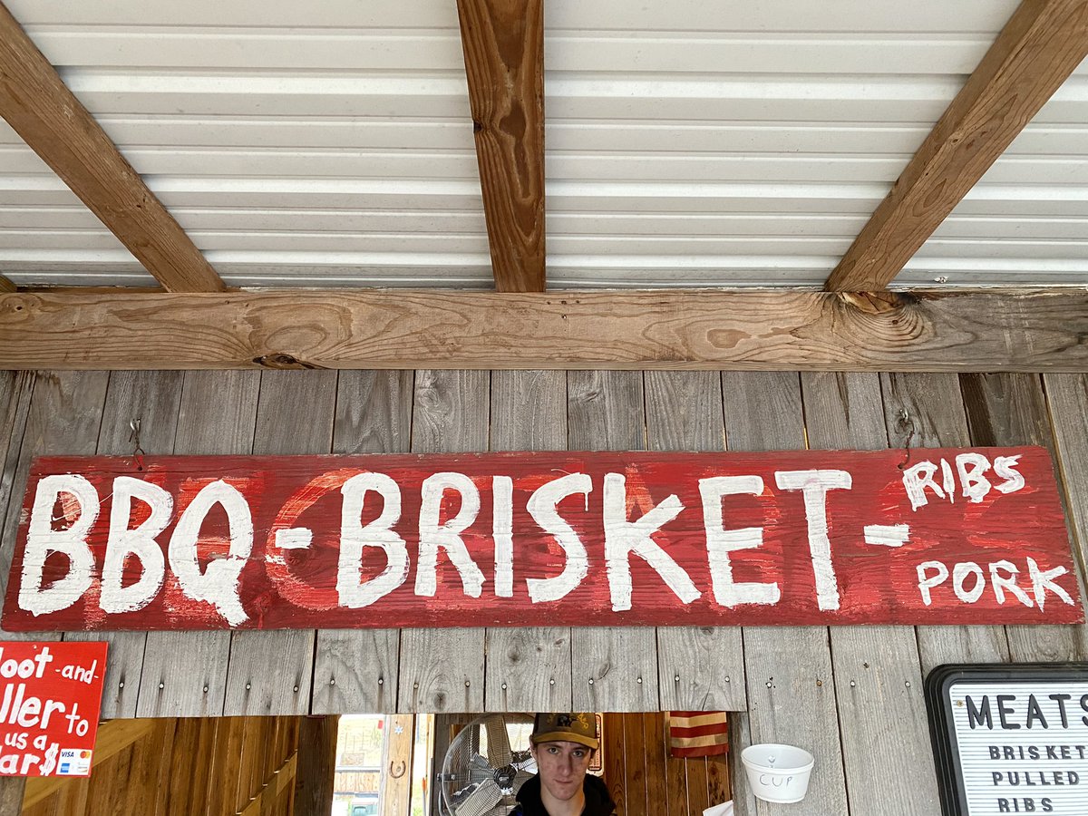 I saw a bunch of BBQ joint signs today, but this was my favorite. They hastily painted over an old sign from the produce stand they replaced. Can you read what is used to say under the BBQ Brisket part? It made me laugh.