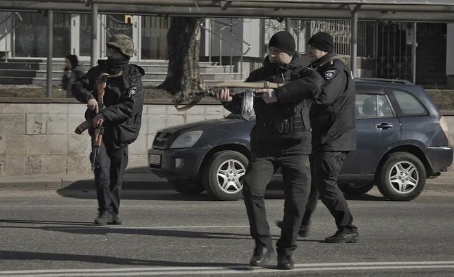 Jake_Hanrahan's tweet photo. From my friend Phil Pendlebury who’s on the ground in Kyiv: “The situation is extremely tense as authorities monitor for Russian Saboteurs. These two men were arrested. As another vehicle approached, officers pointed their weapons at a terrified civilian sitting in the car.” https://t.co/Rr23EQRJox