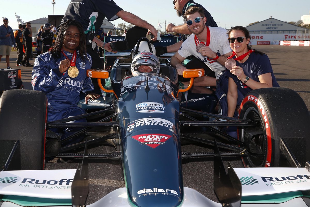 IndyCar's tweet photo. .@erinjackson480, @jrmantia, and @BrittanyBowe are showing off the @Olympics hardware.

Welcome to the @GPSTPETE!

#INDYCAR // #TeamUSA // #FirestoneGP https://t.co/09OVQffCps