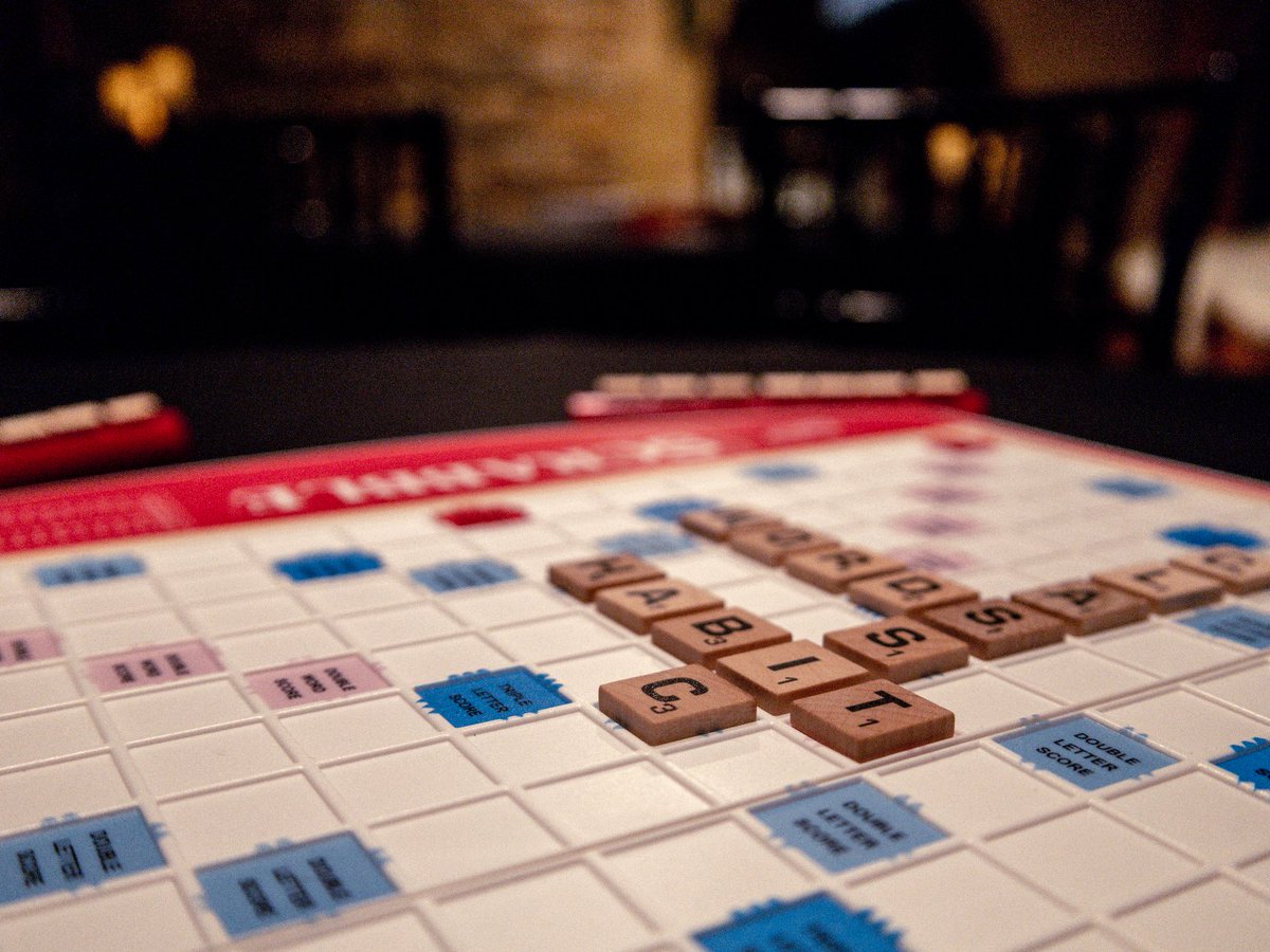 RPGLawrence's tweet photo. While we have multiple copies of Scrabble, we just have one copy of Scrabble Deluxe (in which the board spins to face each player). Our #RestuarantWeek menu is still going strong, so come on down to have a bite and exercise that brain. #boardgame #PressPauseComePlay #RPGLawrence https://t.co/8W6x4m3hn2