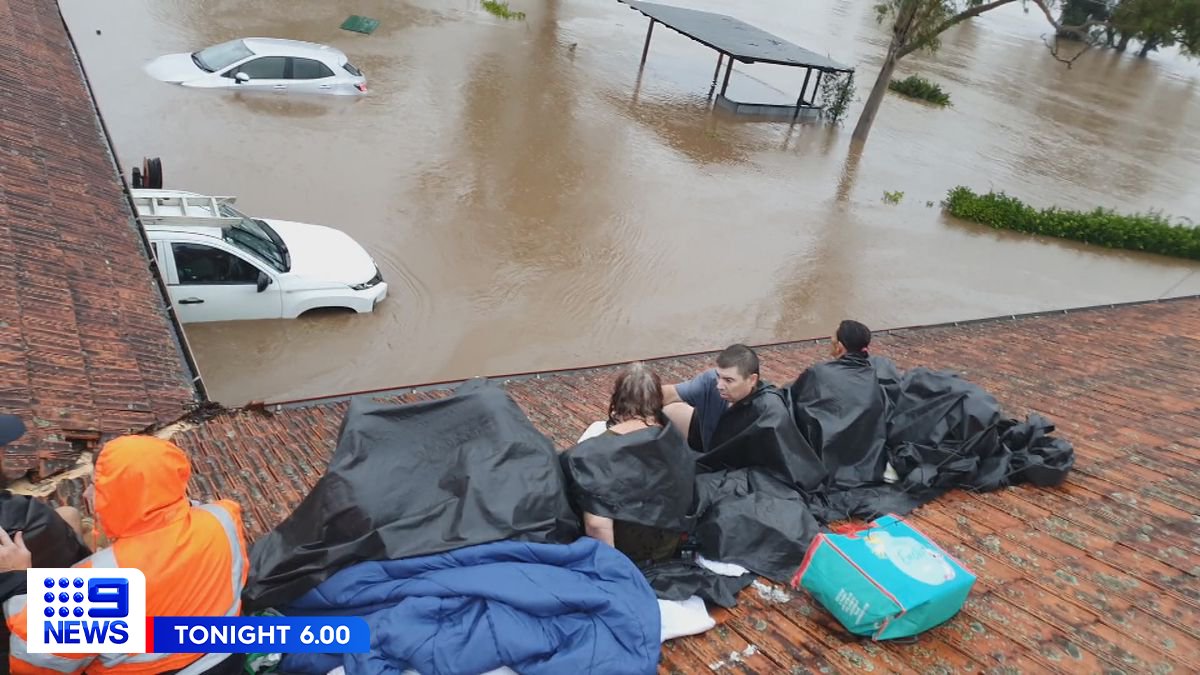 Dozens of Lismore residents are stranded on their roofs as floodwaters ...