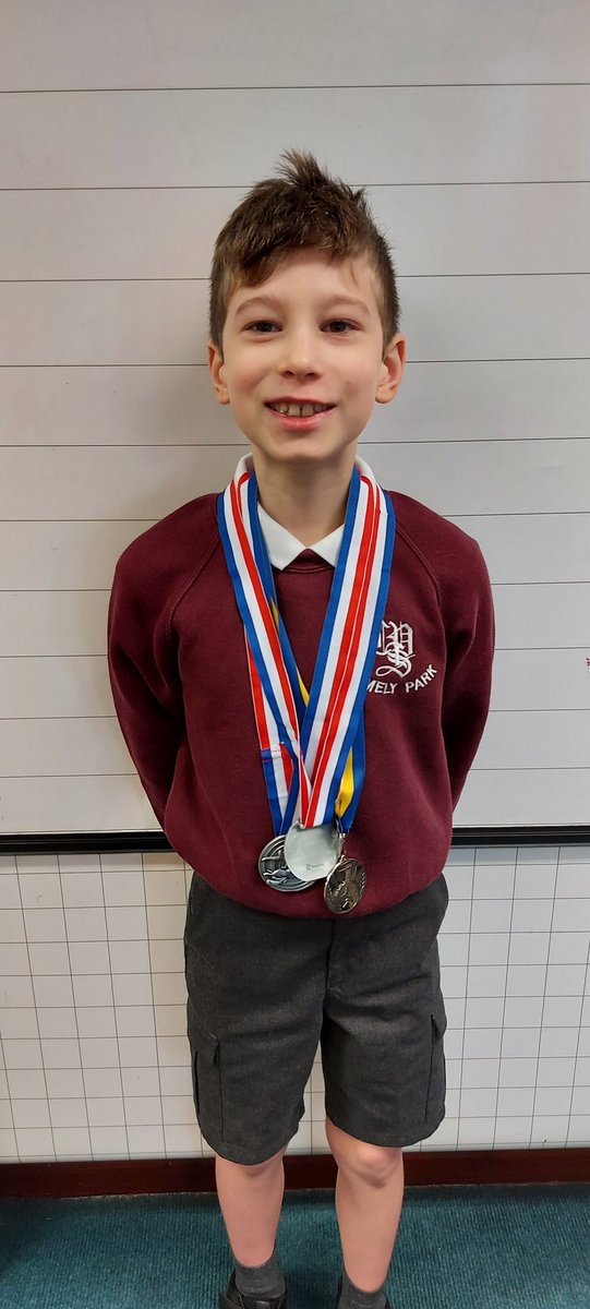 Our successful swimmer showing his class his medals from his swimming gala at the weekend!