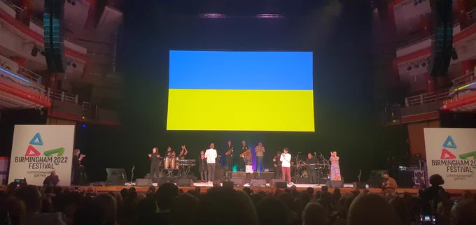 Image showing a concert stage with a projector screen displaying the Ukraine flag.